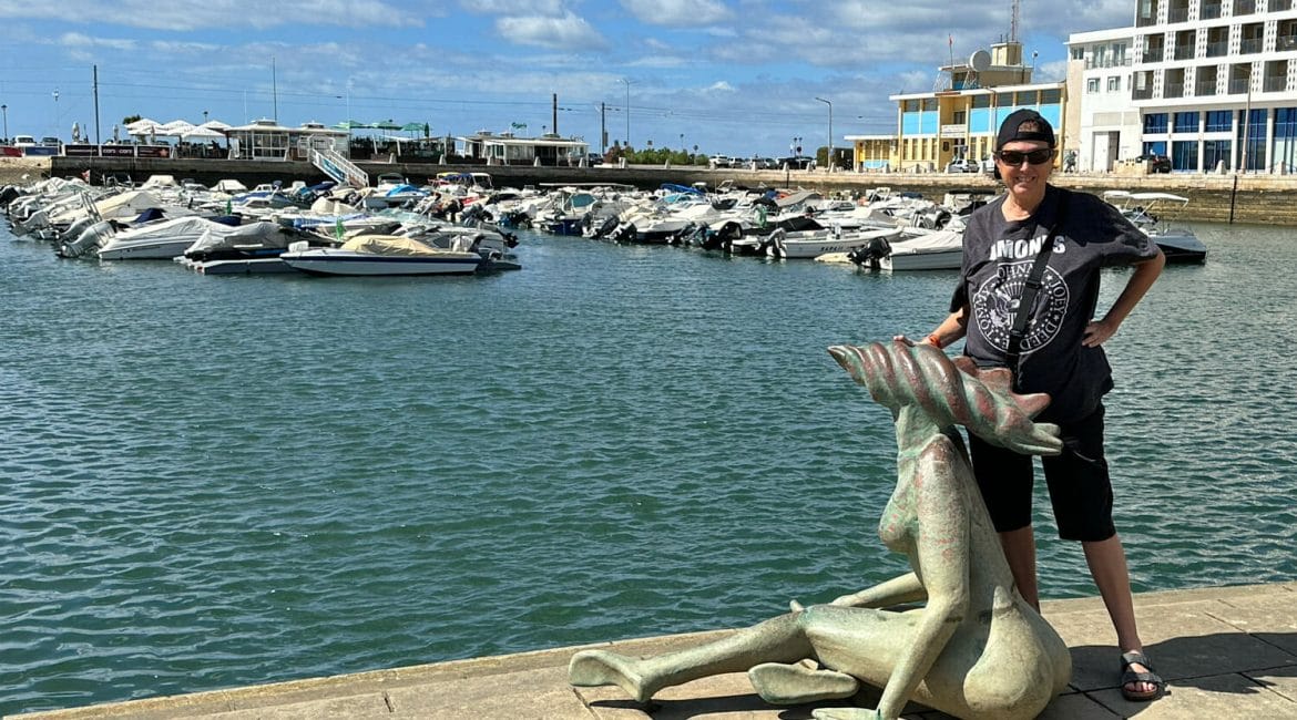 hilary topper on a dock in Faro, Portugal